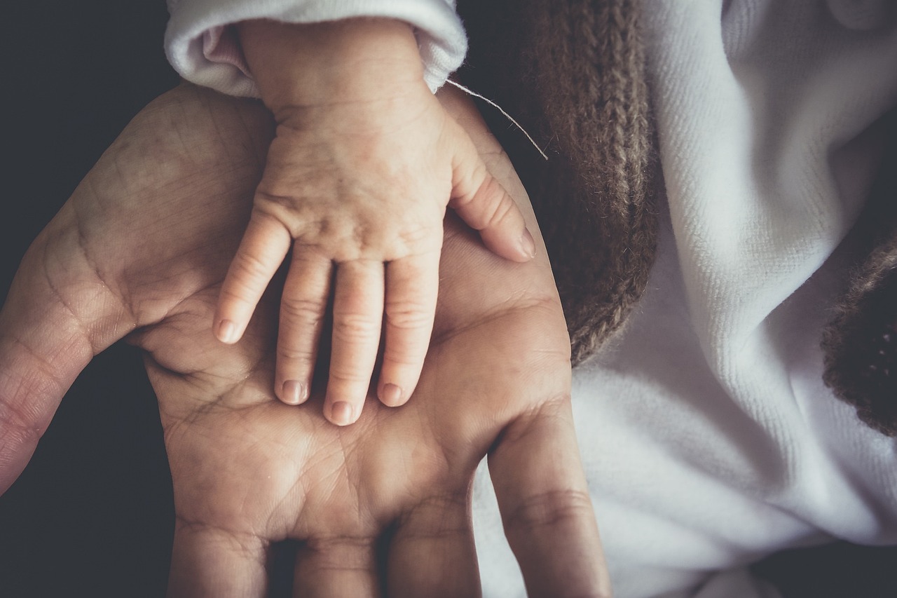 baby hand holding her mother