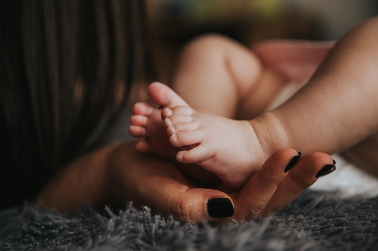 mother holding her babys feet